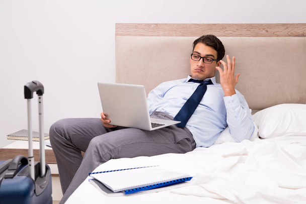 Businessman working during business trip in hotel - Photo, image