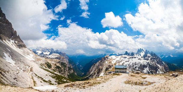 Dolomite Alps rocky mountain range and refuge at tre cime di lavaredo. Panoramic View - Photo, Image