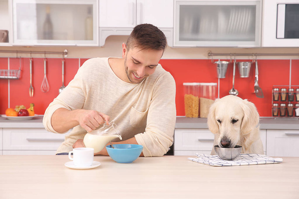 Man and  dog enjoying breakfast  - Φωτογραφία, εικόνα
