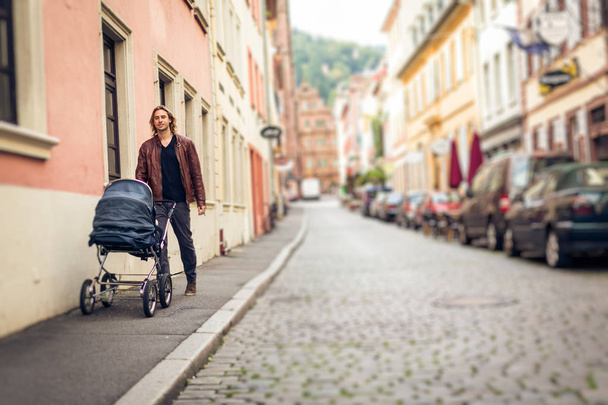 Young Father With Baby Stroller In The City - Photo, image