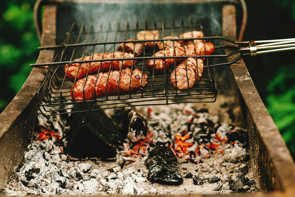  grilled sausages roasting on grates - Photo, Image