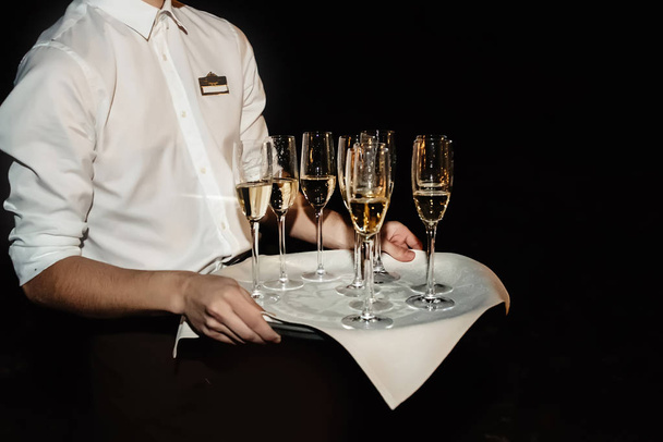 waiter holding tray with stylish glasses  - Фото, изображение