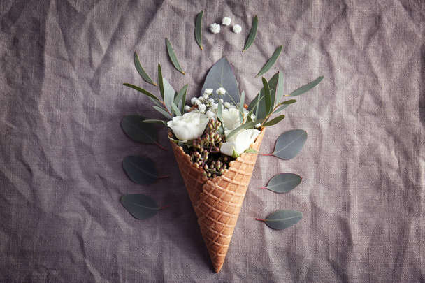 Waffle cone with composition of flowers  - Фото, зображення