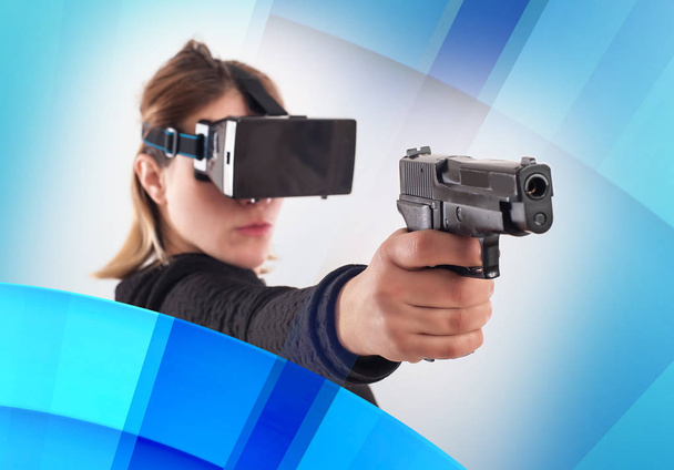 Woman play VR shooter game with virtual reality gun and vr glass - Foto, afbeelding
