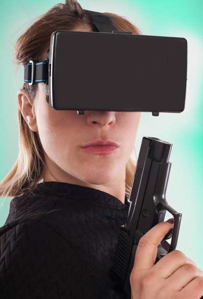 Woman play VR shooter game with virtual reality gun and vr glass - Photo, Image