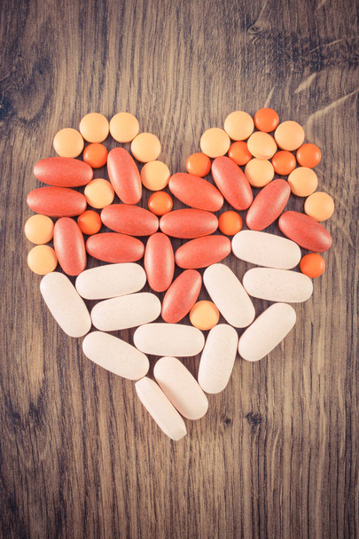 Vintage photo, Heart shaped colorful medical pills and capsules, health care concept - Foto, immagini