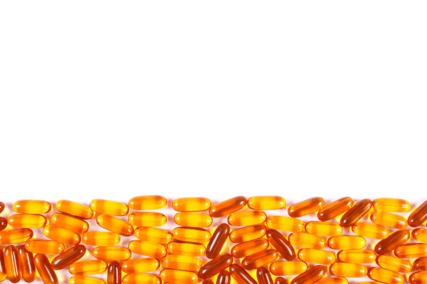 Orange medical capsules on white background, health care concept, copy space for text - Fotografie, Obrázek