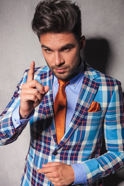 elegant man in checkered suit gesturing for you to behave - Foto, Imagen