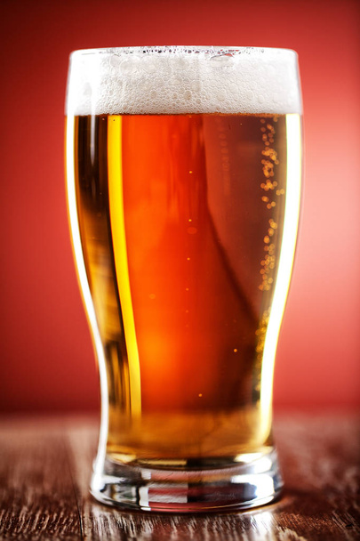 Pint of Beer on a table - Φωτογραφία, εικόνα