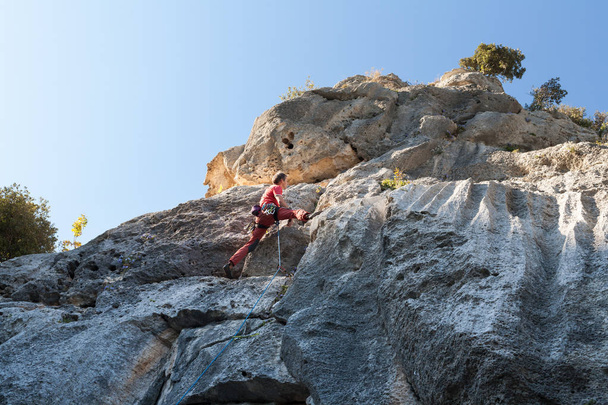 Man climbing on a limestone wall - Photo, image