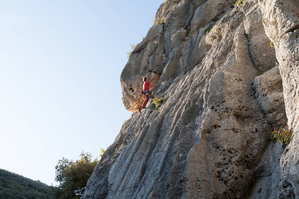 Man climbing on a limestone wall - Фото, изображение