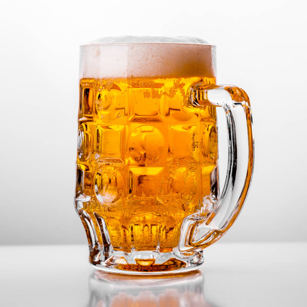 Glass of fresh beer on white background - Фото, изображение