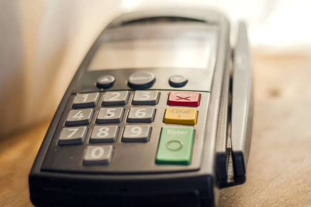 Payment with credit card - businessman holding pos terminal. Payment card in a bank terminal. The concept of of electronic payment.Color image of a POS terminal - Foto, Imagen