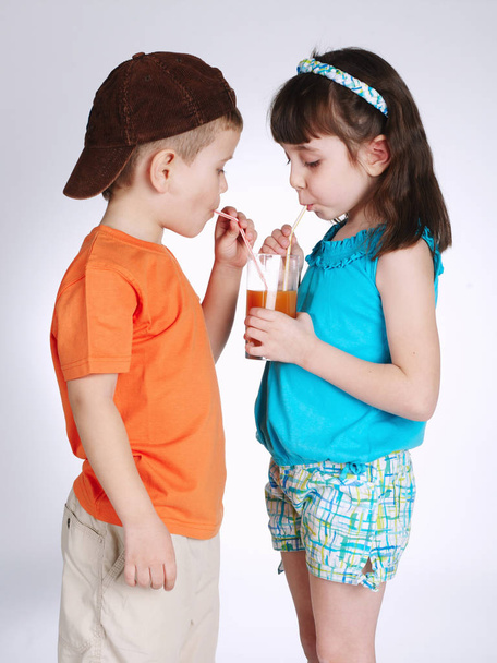 little boy and girl drinking juice - Fotografie, Obrázek