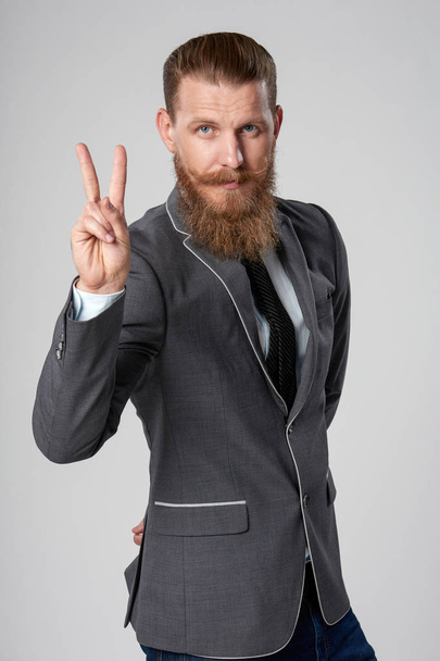 Successful business man showing V sign - Photo, image