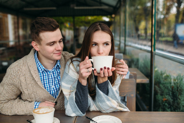 Couple sitting at sidewalk cafe - Photo, Image