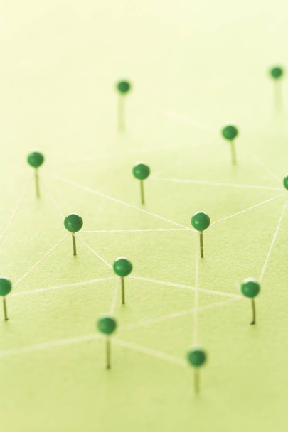 Grren καρφίτσες σε πράσινο φόντο τη δημιουργία ενός δικτύου - Φωτογραφία, εικόνα