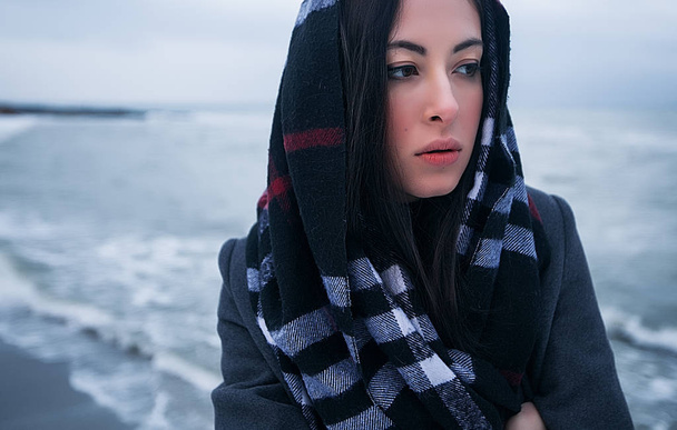  beautiful girl in headscarf standing on seacoast - Photo, Image