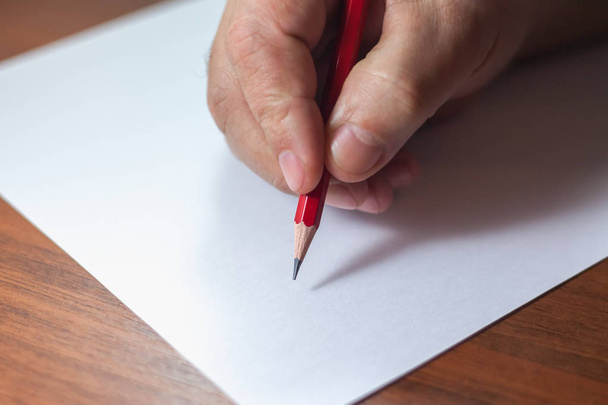 A close photo of a persons writing a letter with a pencil - Photo, Image
