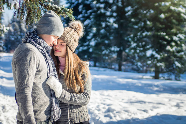 Couple in love hugs in winter forest - Фото, изображение