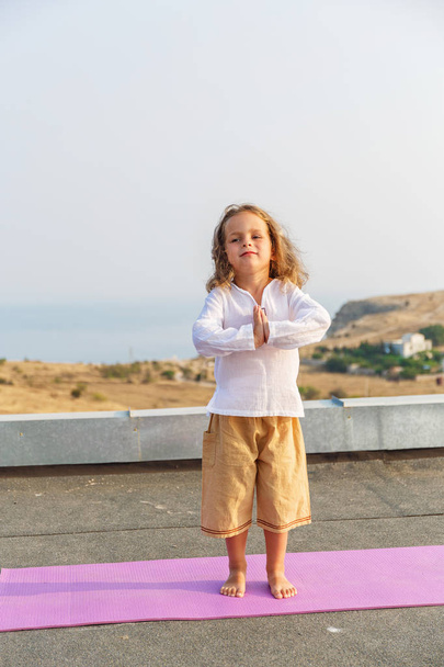 Baby doing yoga on the roof - Photo, Image