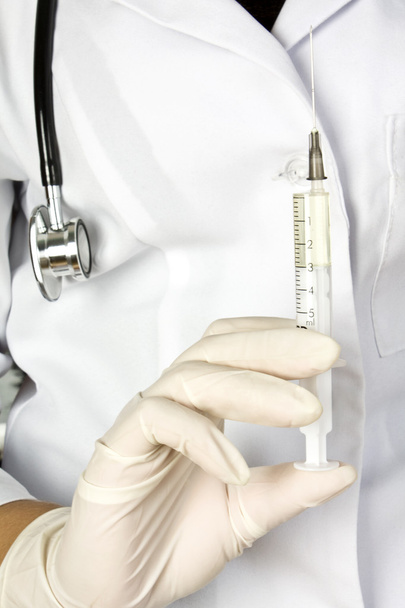 syringe in a hand - Фото, изображение