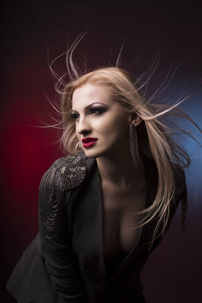Stunning young blonde woman with hair in motion - Fotografie, Obrázek
