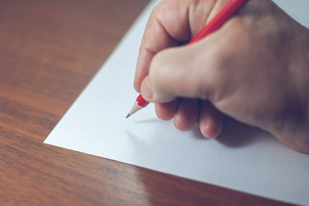 A close photo of a persons writing a letter with a pencil - Foto, imagen