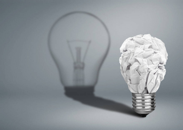 Bulb with crumpled paper and shadow, Idea creative concept - Фото, зображення