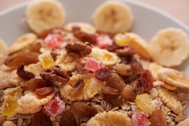 flakes with dried fruit, granola on the plate - Photo, Image