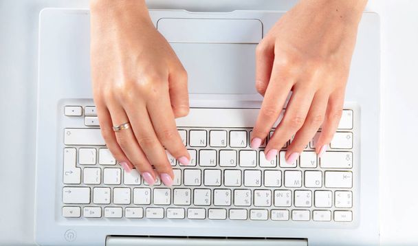 Woman working on laptop, sitting at the desk - Фото, зображення