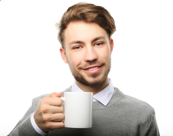 Portrait of handsome young man with cup, isolated on white. - Фото, зображення