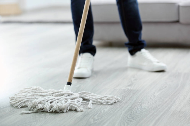  man with mop cleaning floor   - Zdjęcie, obraz