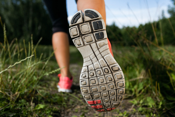 Woman and running shoes in forest, exercising in nature - Photo, Image