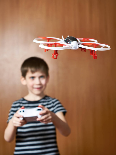 Happy little boy drives toy quadcopter drone - Fotoğraf, Görsel