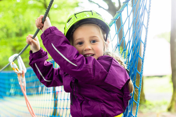 Girl climbing in high rope course - Photo, Image