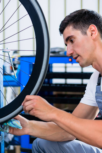 Mechanic repairing bicycle - Photo, image