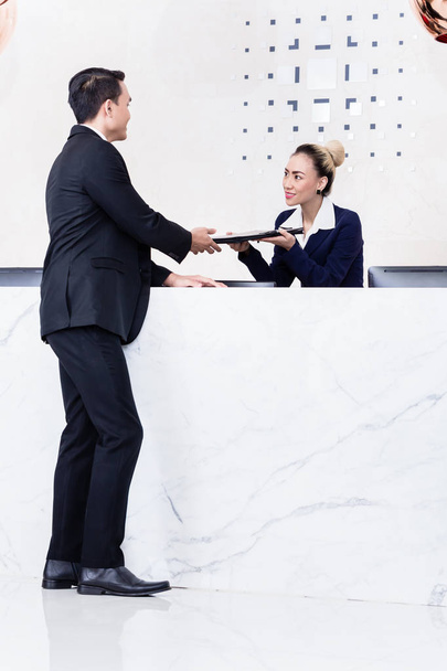 Applicant giving his documents to receptionist - Photo, Image