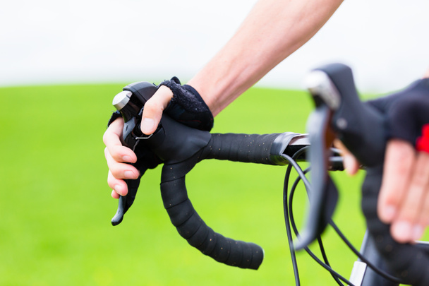 Sport man having Hands on handlebar of racing bike - Foto, Imagen