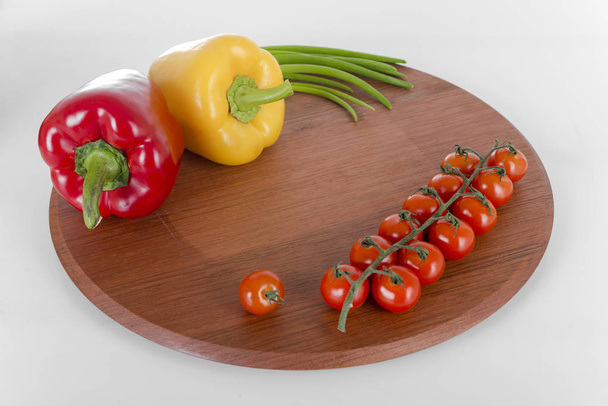 assorted vegetables and fruits, surrounding an empty cutting sur - Fotografie, Obrázek