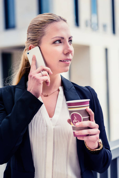 Business woman with phone and coffee - Photo, Image