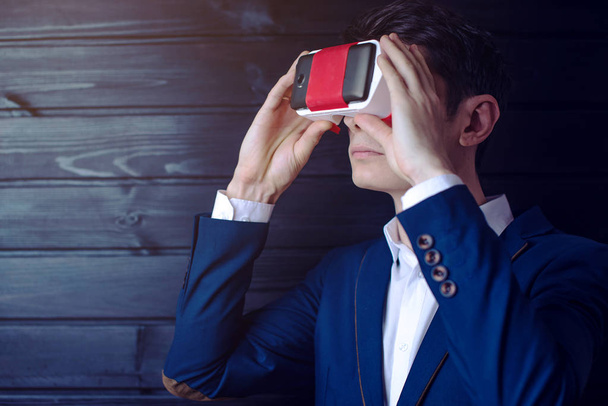 Businessman in suit uses a colorful virtual reality glasses - Foto, Imagem