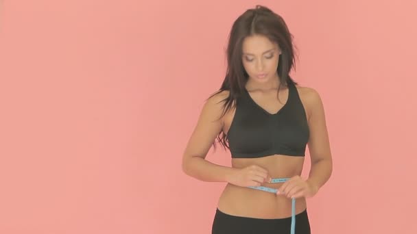 Shapely woman measuring her waist - Footage, Video