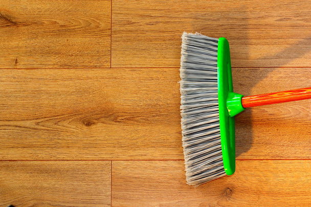 cleaning wooden floor with broom - Foto, imagen