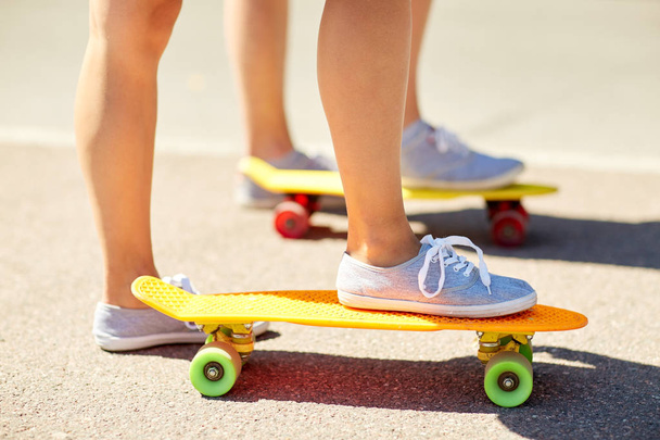 close up of female feet riding short skateboard - Zdjęcie, obraz