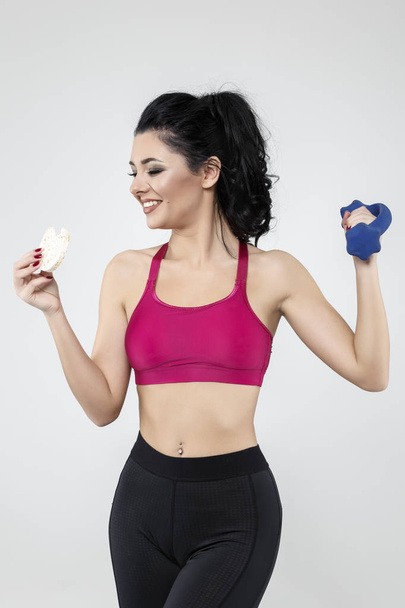diet sporty young woman eating cereal bar - Photo, Image
