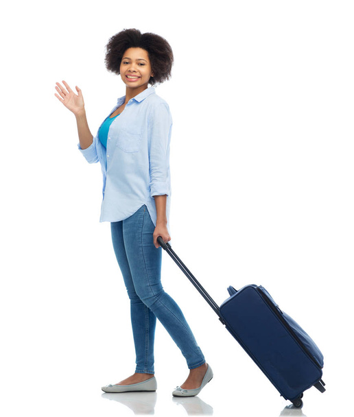 happy woman with travel bag waving hand - Foto, imagen