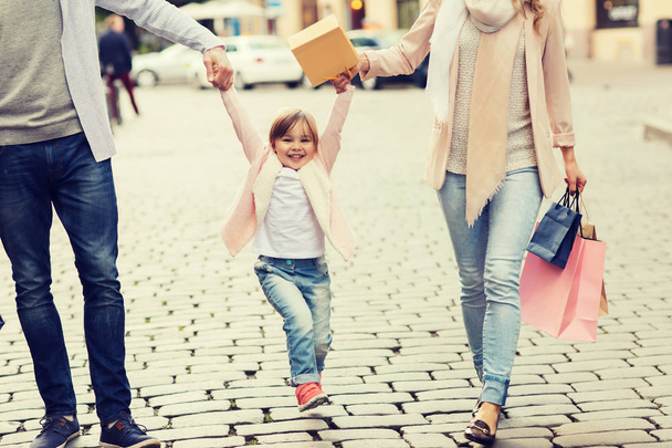 happy family with child and shopping bags in city - Photo, image