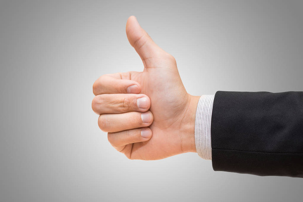 Empresário mão dando polegares sobre fundo cinza
 - Foto, Imagem