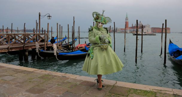 Human in venetian mask standing at pier - Photo, Image